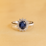 Load image into Gallery viewer, White Gold Halo Ring with Deep Blue Centerpiece and Brilliant Cut Surround Handcrafted Royal Elegance
